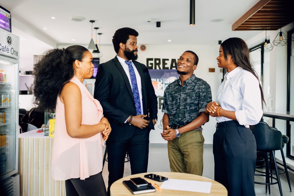 Business consultants in discussion during a client strategy meeting in a Lagos office